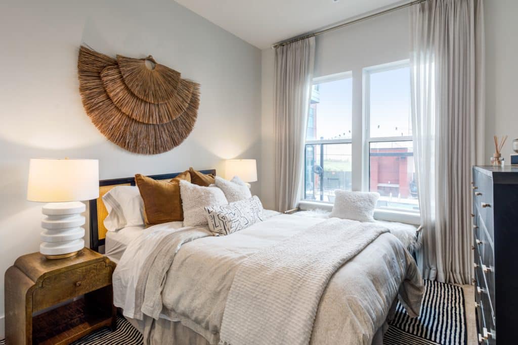 Modernly furnished bedroom with large windows in apartment at Margaux Midtown